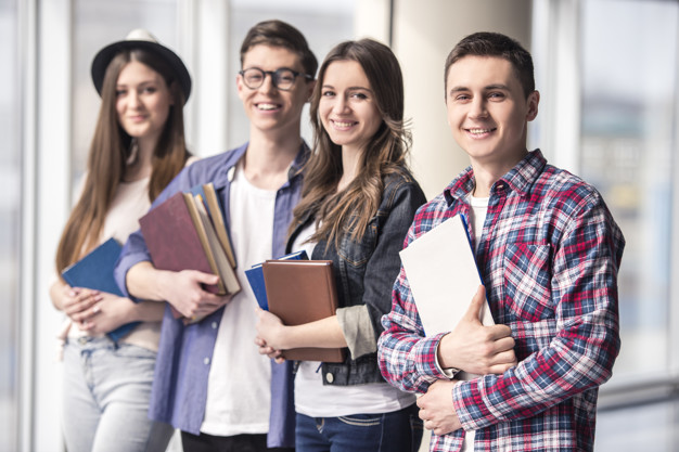 Group of happy young students in a university.