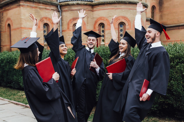 happy-college-graduate-show-diplomas-ceremony-outside-university_115086-937